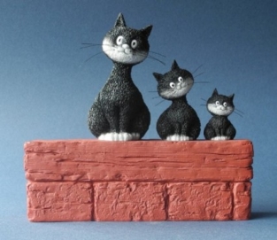 3 Poezen Dubout op een muurtje.